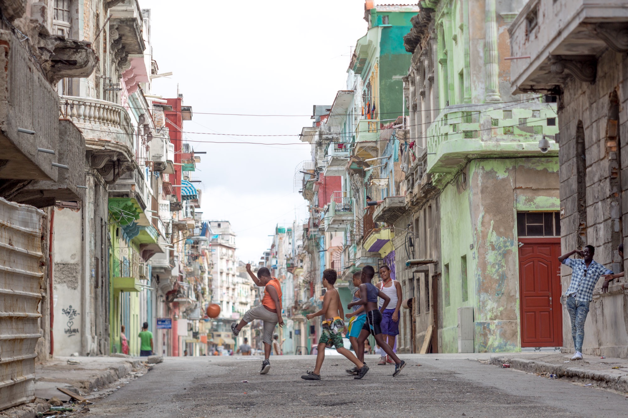 Boys playing soccer on a street in Havana.