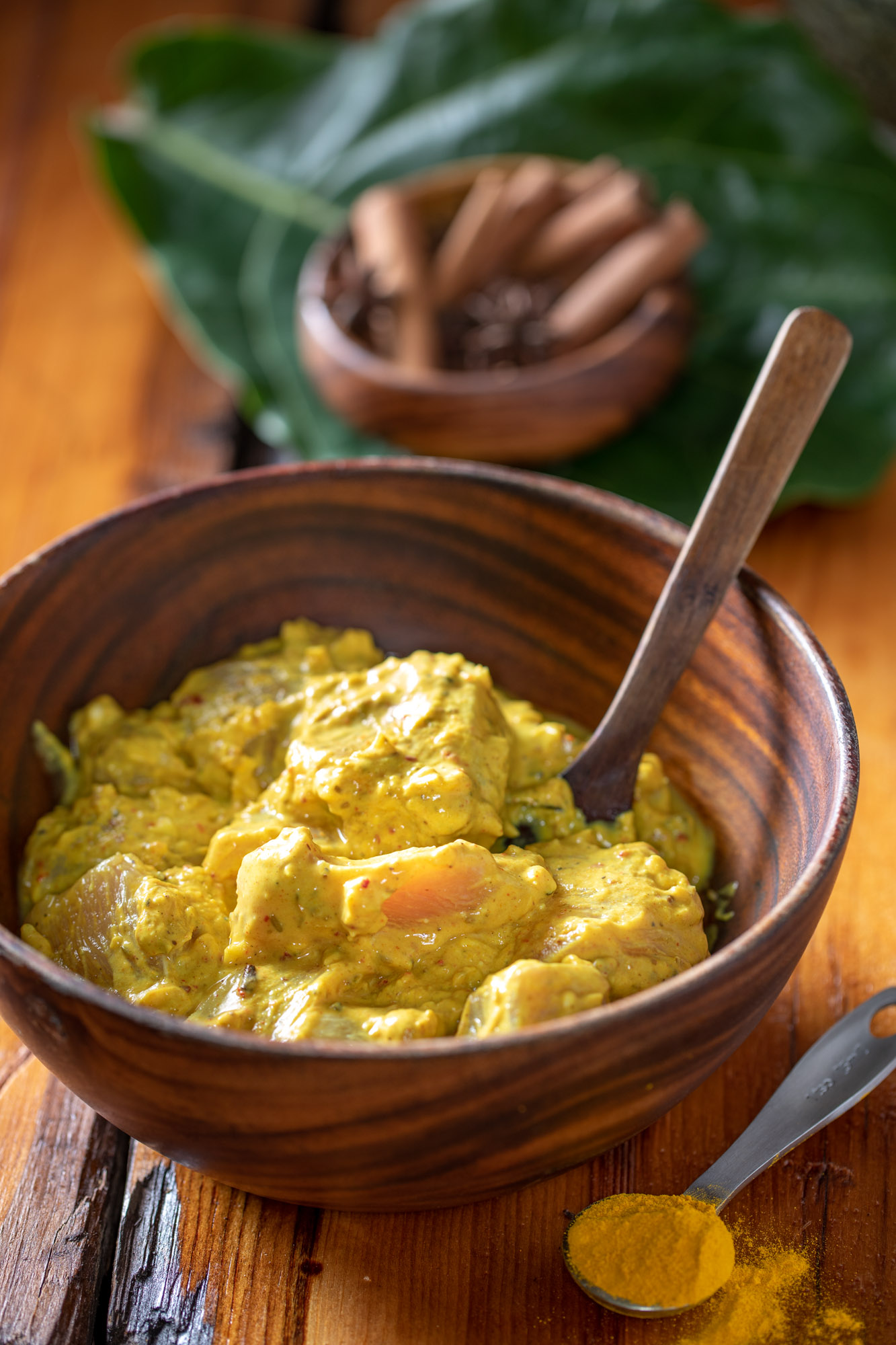 Chicken marinating in a greek yogurt sauce with turmeric