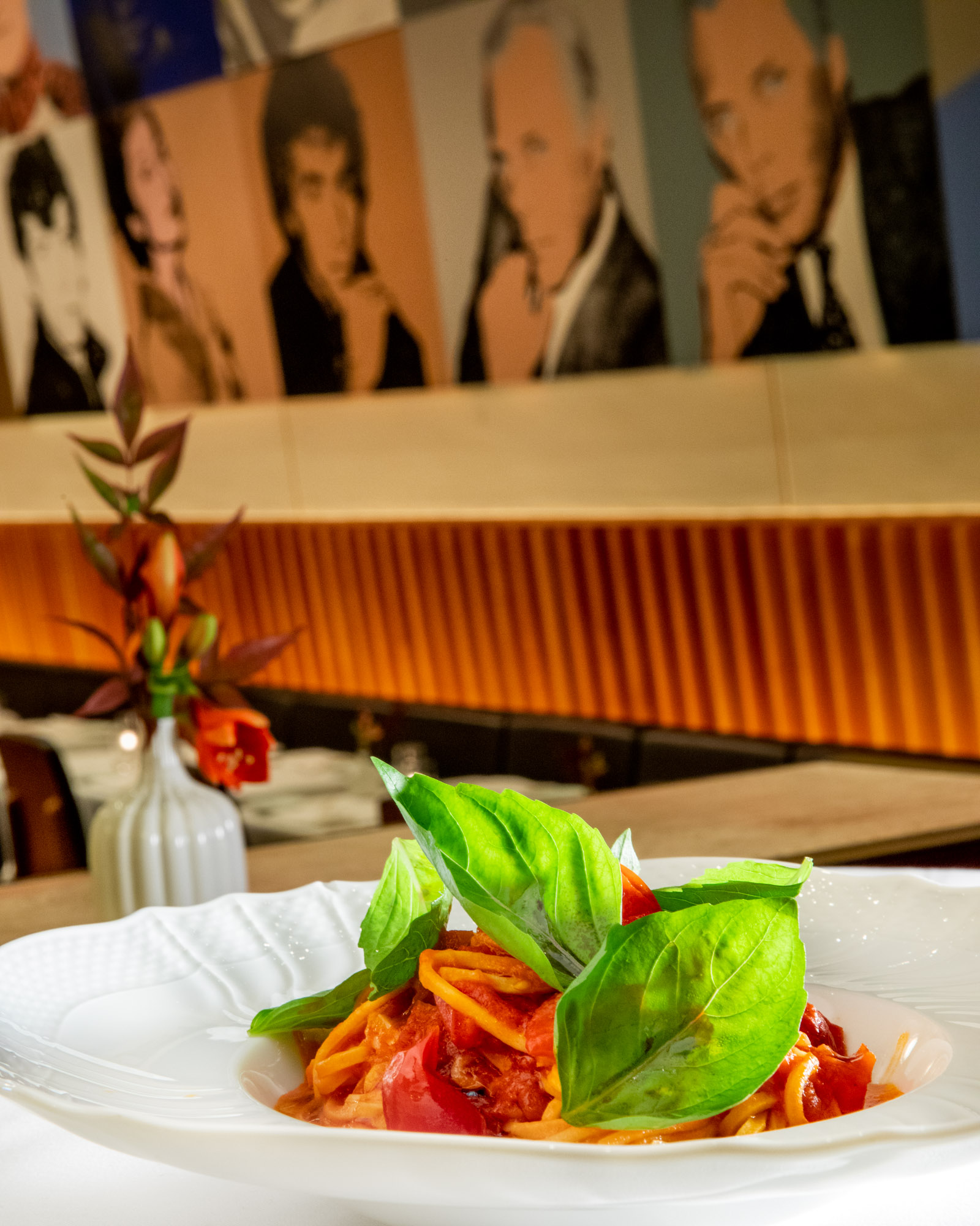 Pasta with a basil garnish photographed in front of Warhol's artwork at Casa Lever in New York City