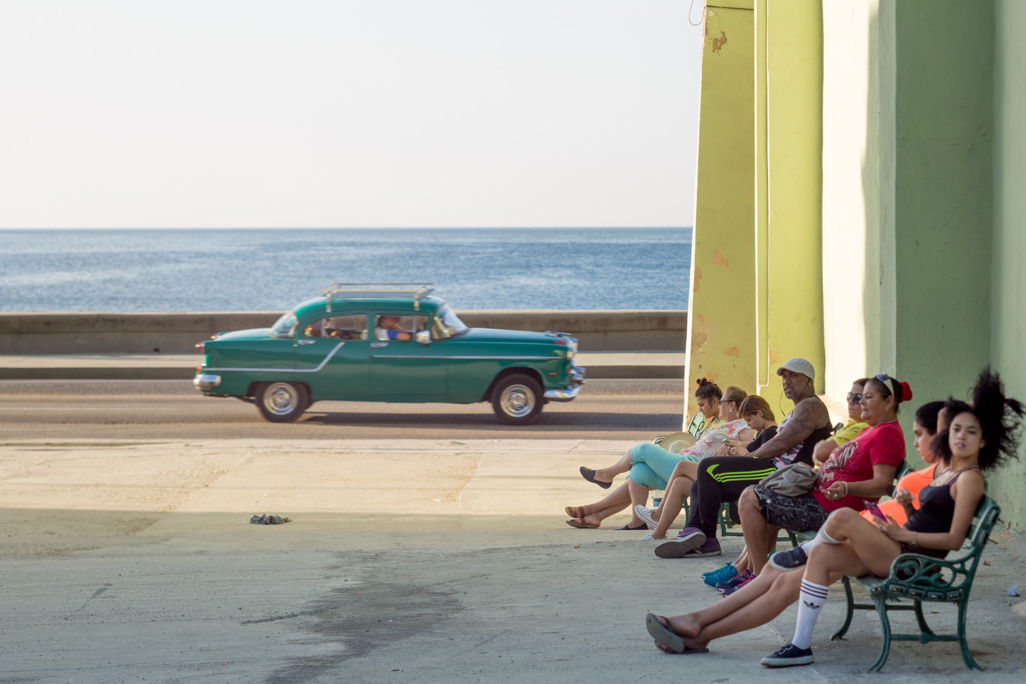 People relaxing on a bench.