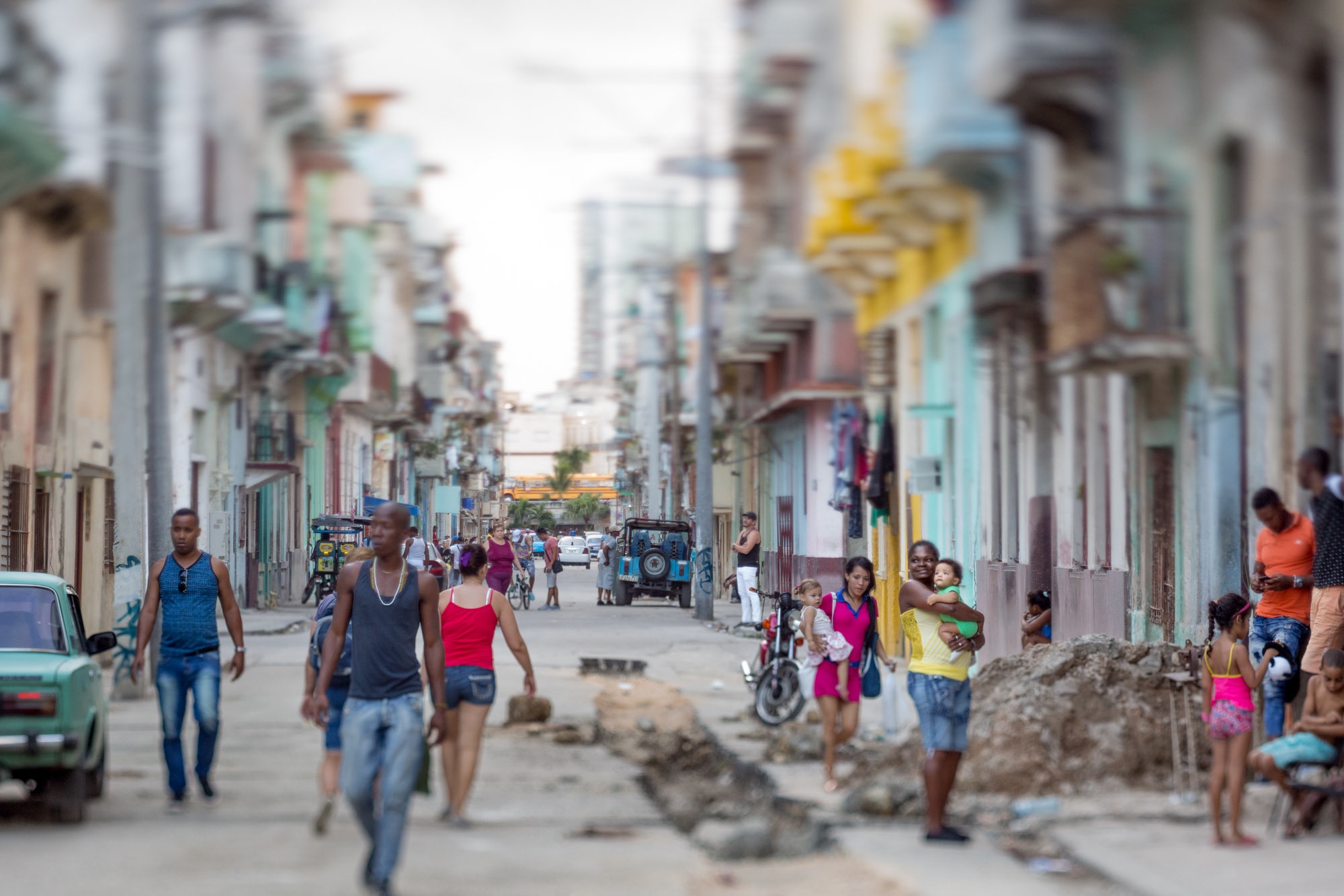 Street scene in Havana with a woman holding a baby.