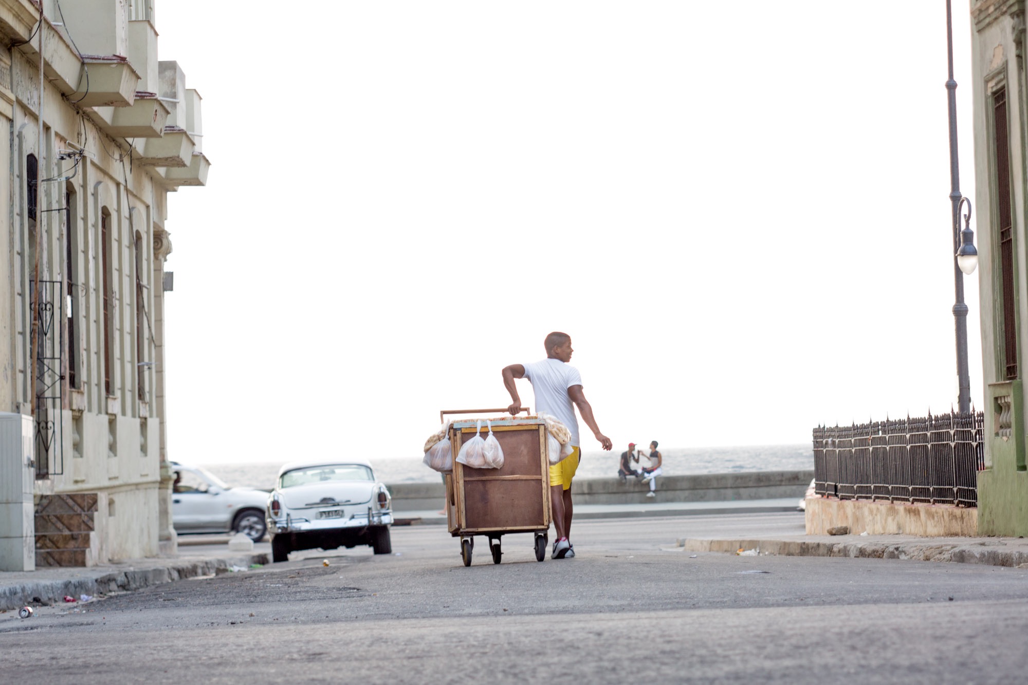 Man pulling a food cart.