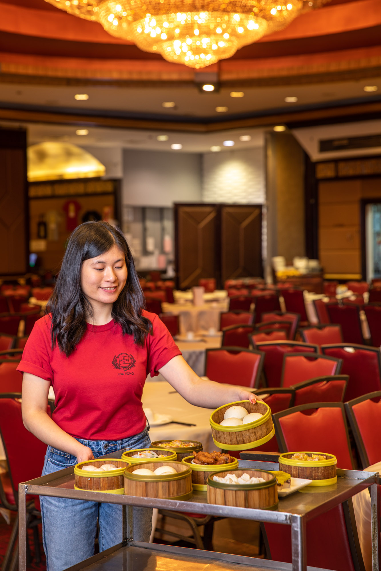 A woman serving food from a Dim Sum cart