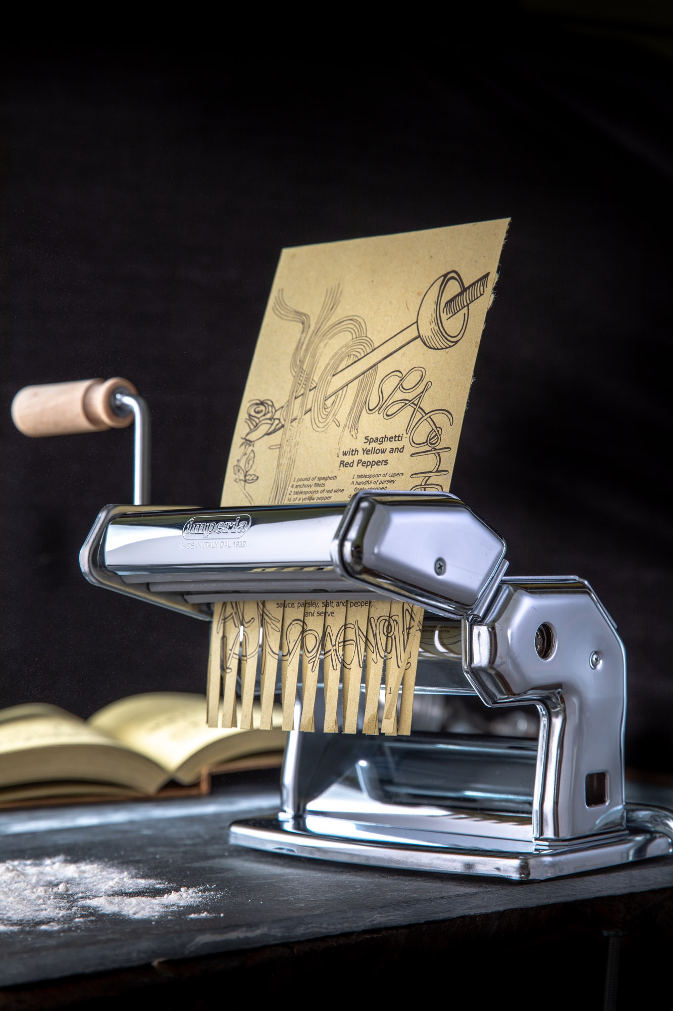 An italian food recipe being shreded in a pasta maker