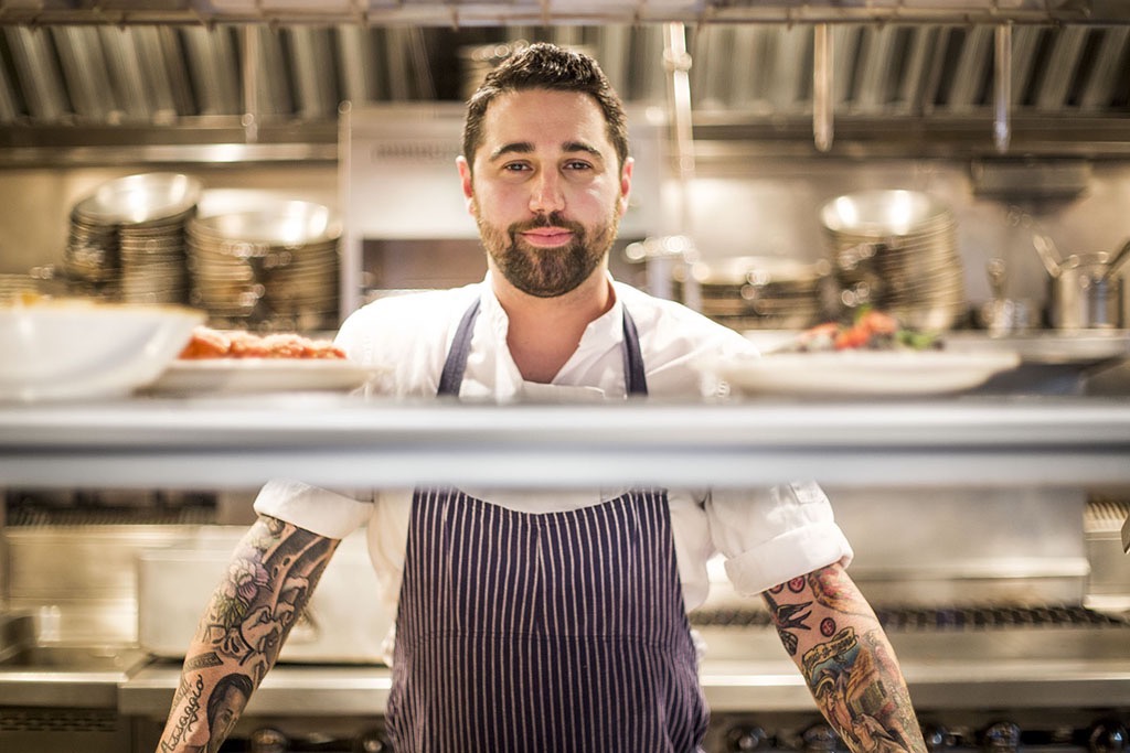 A Foodporn chef posing in the kitchen for a portrait