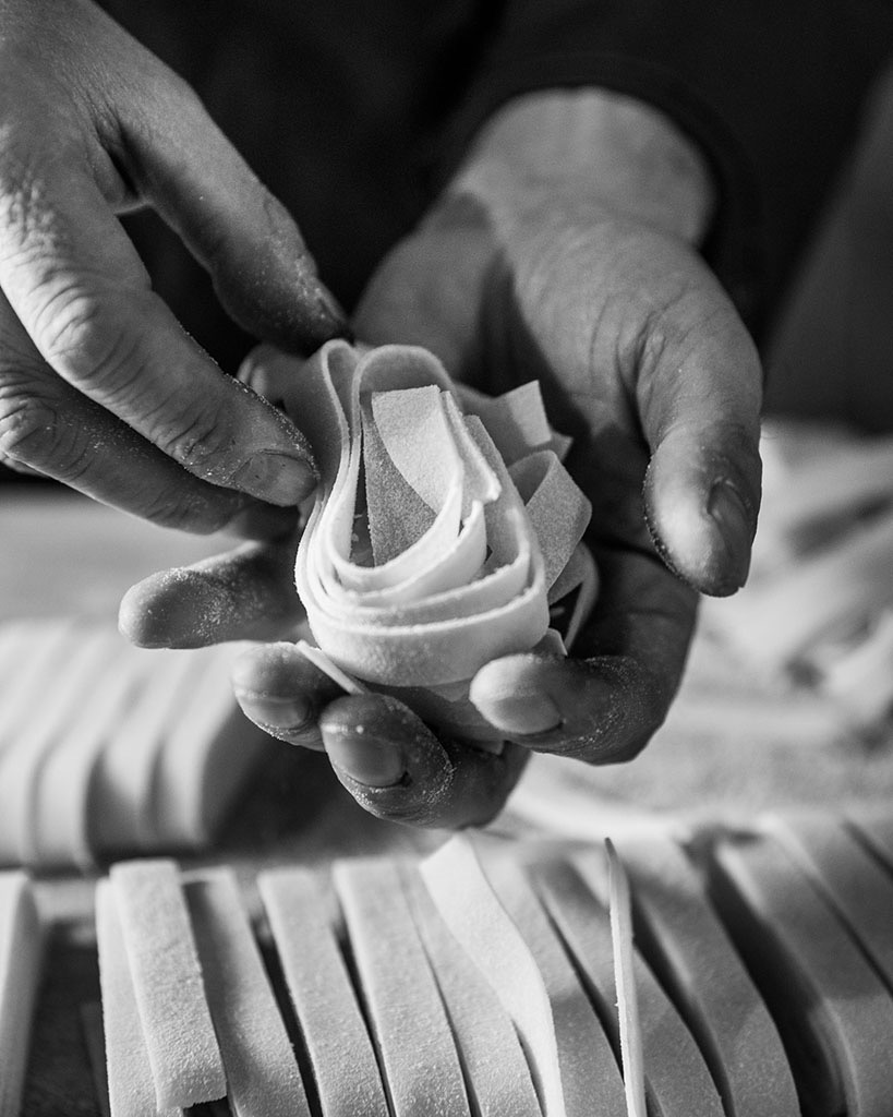 Hands making pasta in the kitchen