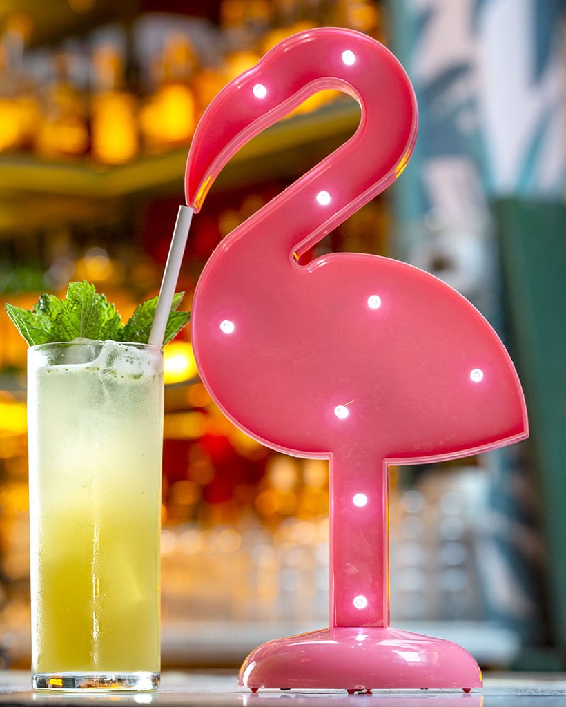 A flamingo sipping on a cocktail at the Happiest Hour bar in New York.