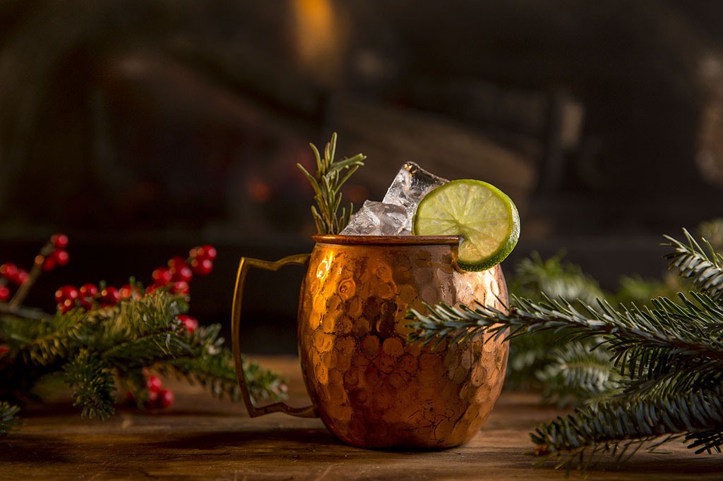 A holiday cocktail sitting by the fire.