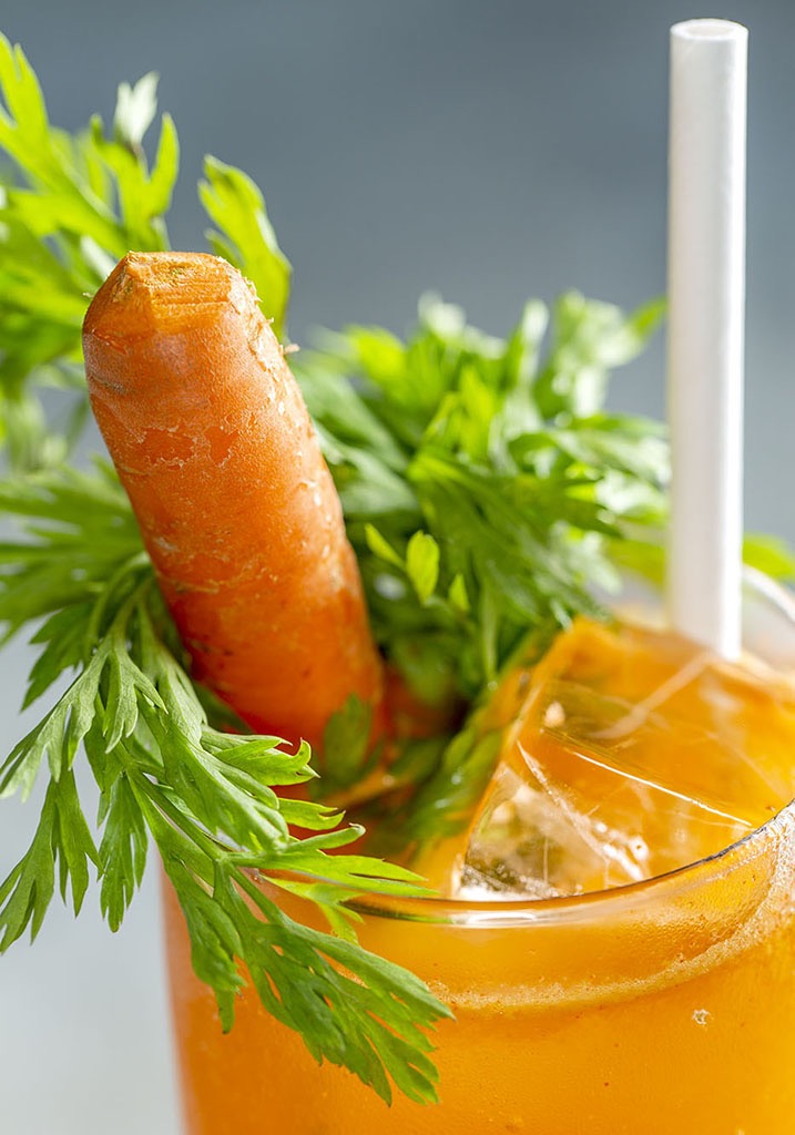 An orange cocktail with a carrot sticking out of it. It's healthy trust me.