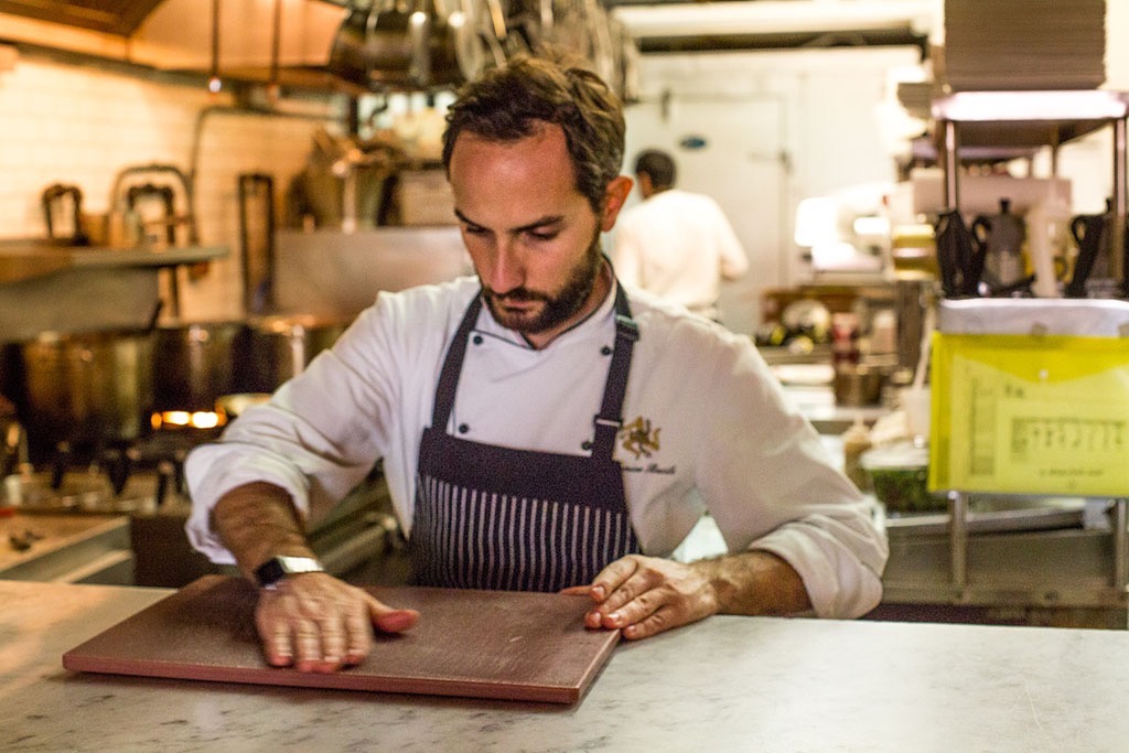 a chef getting ready to plate food at aa restaurant in Brooklyn