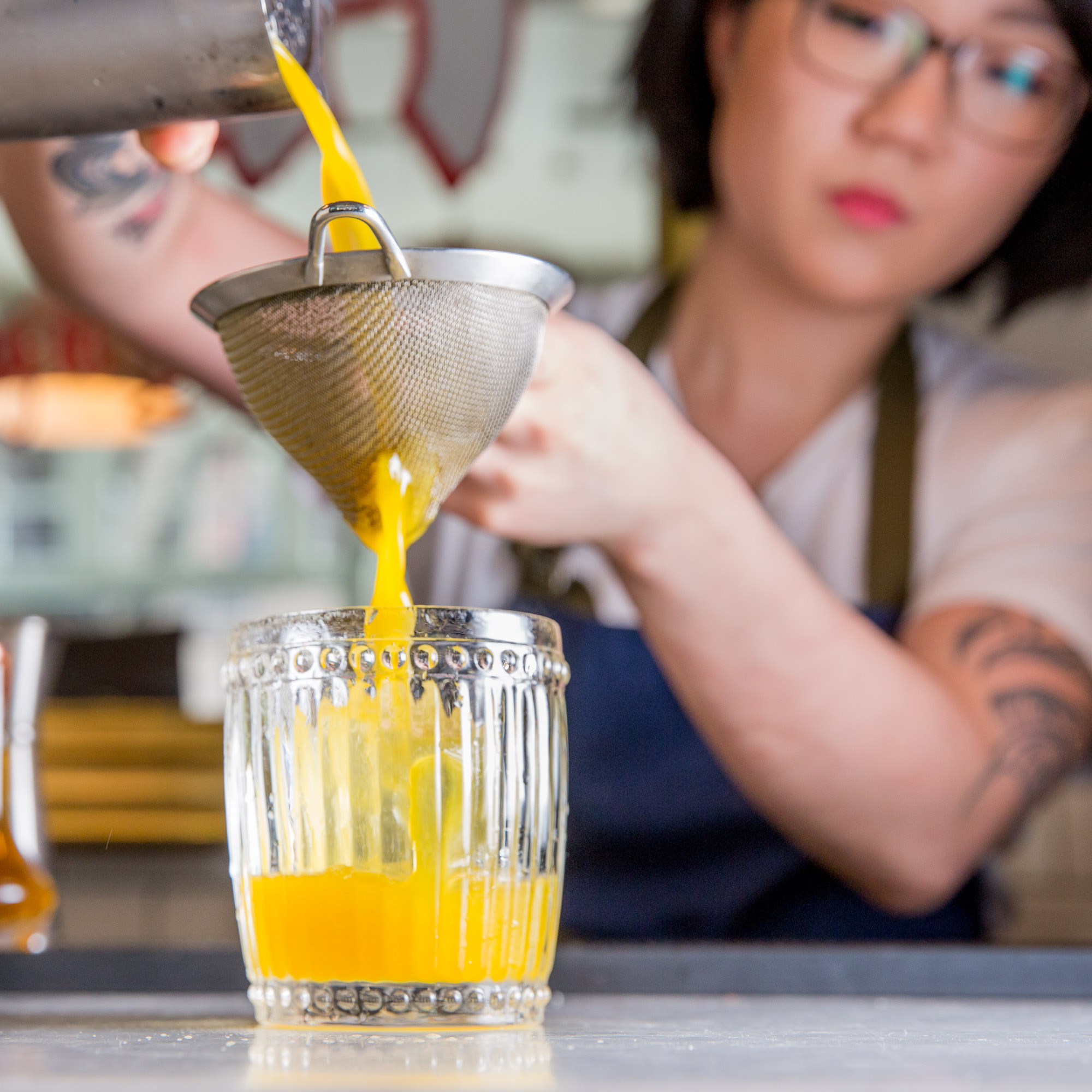 Bartender pouring a cocktail in New York city.